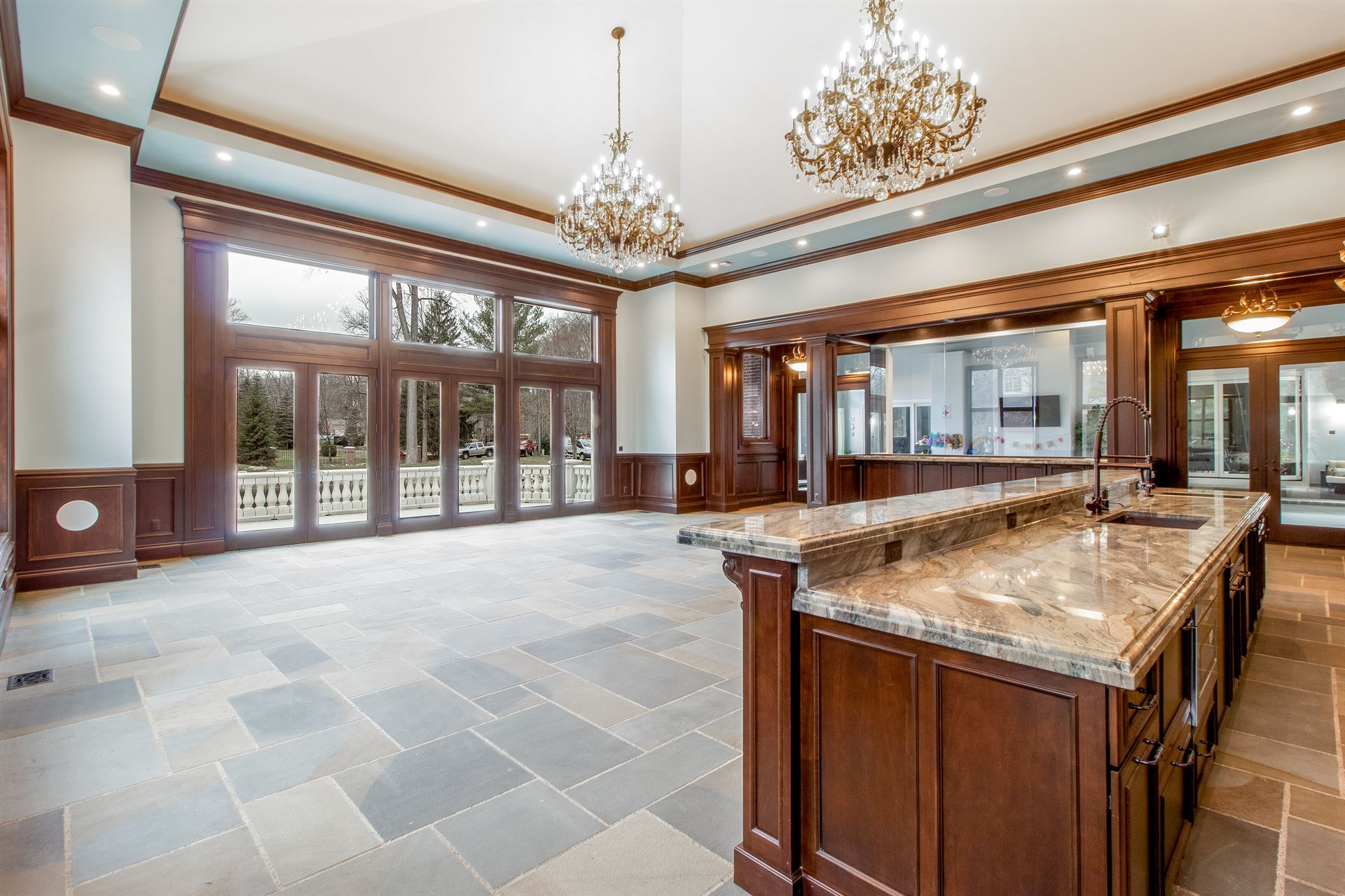 kitchen-and-great-room-with-a-dark-wood-island-and-chandeliers-southeast-mi-optimized