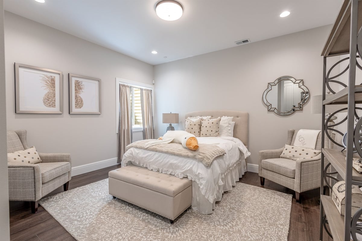 basement-guest-bedroom-with-an-upholstered-bed-and-wood-floors-southeast-mi-optimized