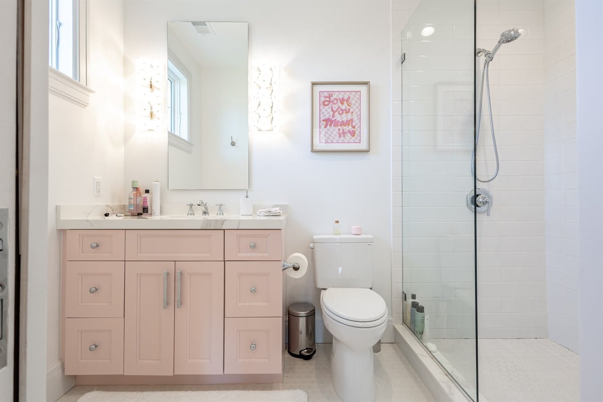 bathroom-with-a-pink-vanity-glass-shower-and-white-subway-tile-southeast-mi-optimized