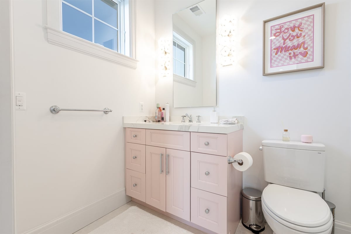 bathroom-with-a-pink-vanity-marble-top-and-framed-mirror-southeast-mi-optimized