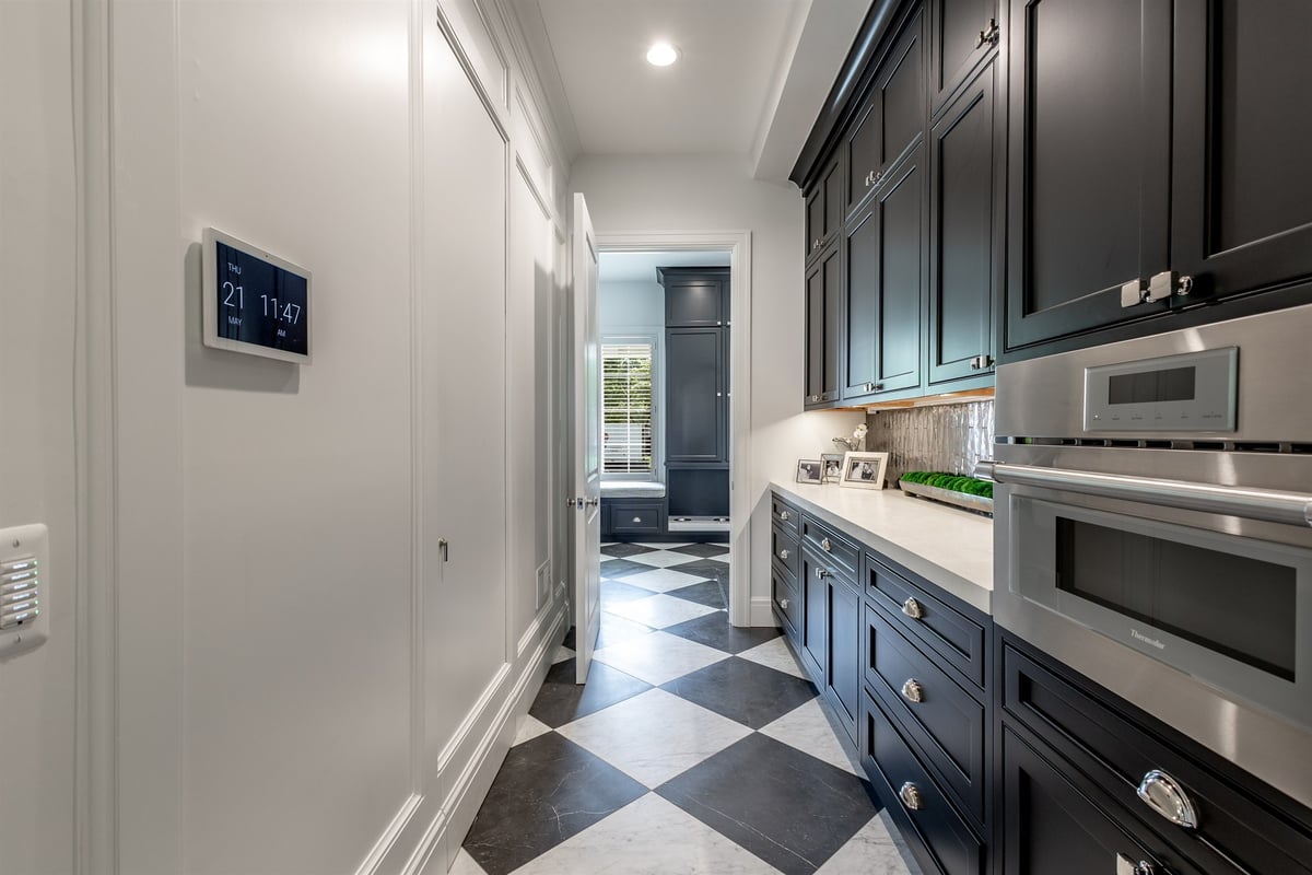 butler-s-pantry-with-black-cabinets-a-wall-oven-and-checkered-floor-southeast-mi-optimized