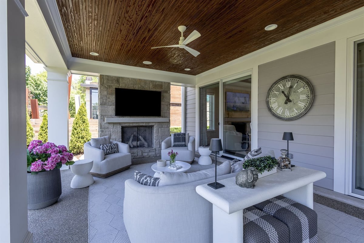 covered-patio-with-a-beadboard-ceiling-stone-fireplace-and-outdoor-seating-southeast-mi-optimized