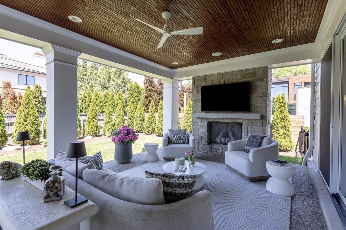 covered-patio-with-a-stone-fireplace-wood-ceiling-and-outdoor-seating-southeast-mi-optimized