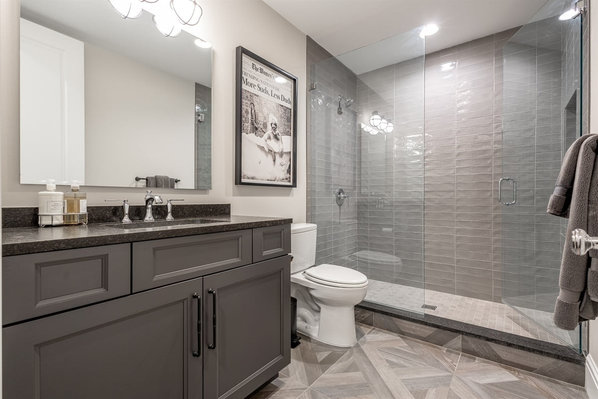 finished-basement-bath-with-a-dark-vanity-and-gray-tiled-walk-in-shower-southeast-mi-optimized