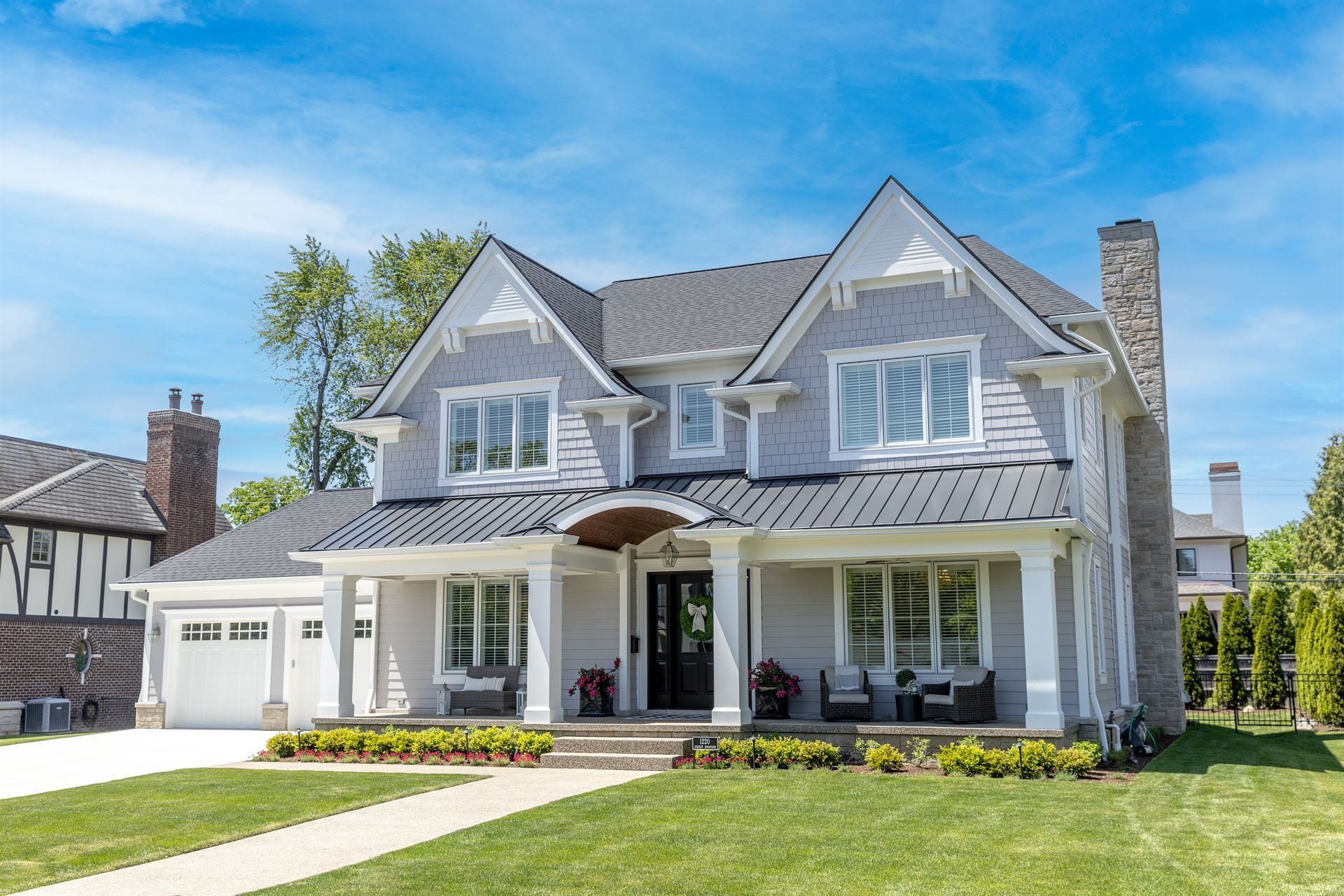 front-angle-of-a-gray-custom-home-with-a-standing-seam-porch-roof-southeast-mi-optimized