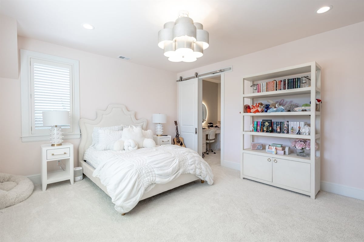 girl-s-bedroom-with-an-upholstered-bed-barn-door-and-built-in-bookshelf-southeast-mi-optimized