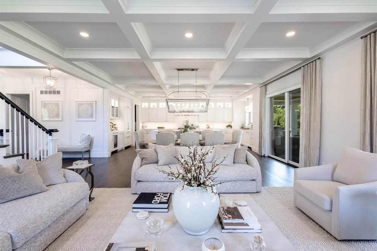 great-room-with-sofas-chairs-and-a-coffered-ceiling-open-to-the-kitchen-southeast-mi-optimized