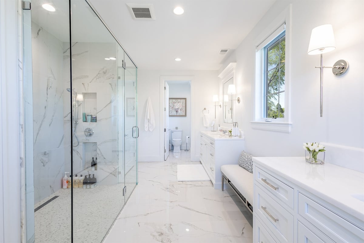 master-bath-with-a-marble-shower-white-double-vanity-and-window-southeast-mi-optimized