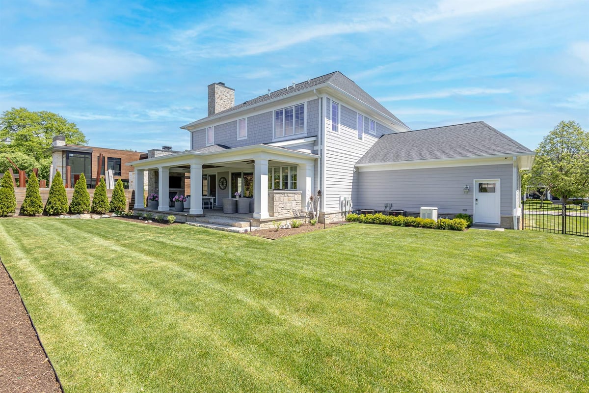 rear-and-side-exterior-of-a-gray-two-story-home-with-a-detached-garage-southeast-mi-optimized