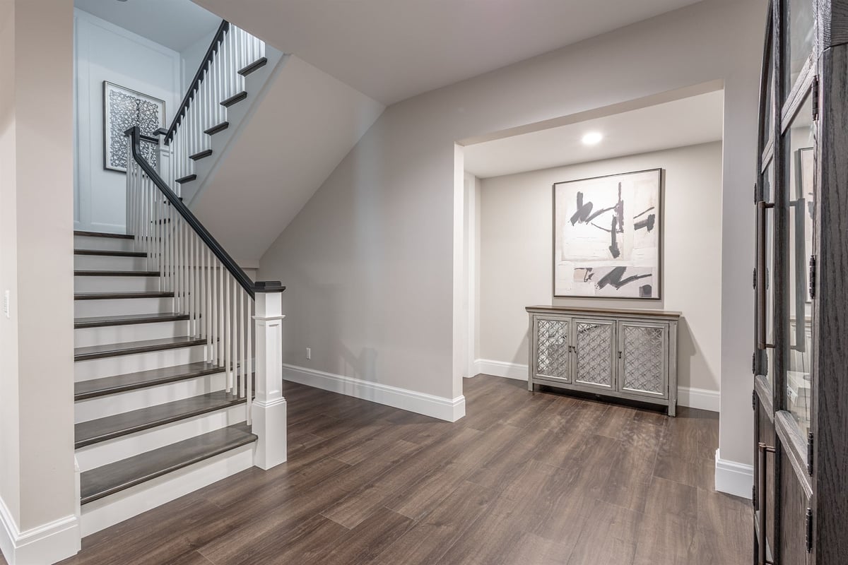staircase-with-iron-balusters-a-dark-handrail-and-a-lower-landing-southeast-mi-optimized