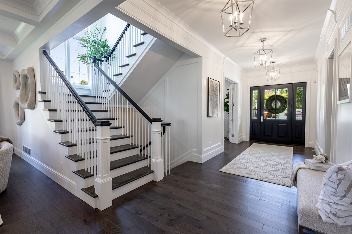 two-story-foyer-with-a-staircase-iron-balusters-and-a-black-front-door-southeast-mi-optimized