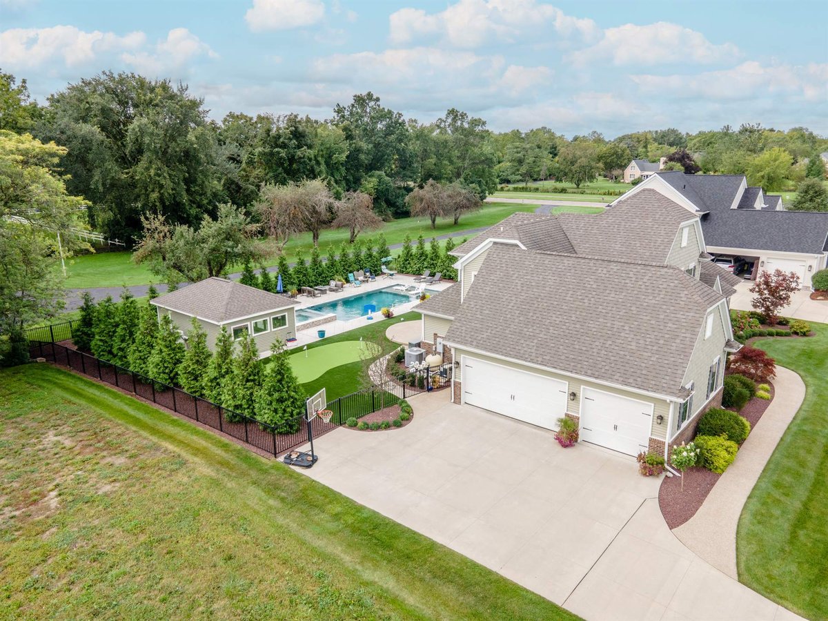 aerial-of-the-home-and-attached-garage-with-the-pool-area-behind-southeast-mi-optimized