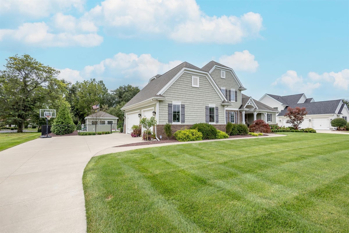 front-and-side-of-the-home-with-a-driveway-and-detached-garage-southeast-mi-optimized