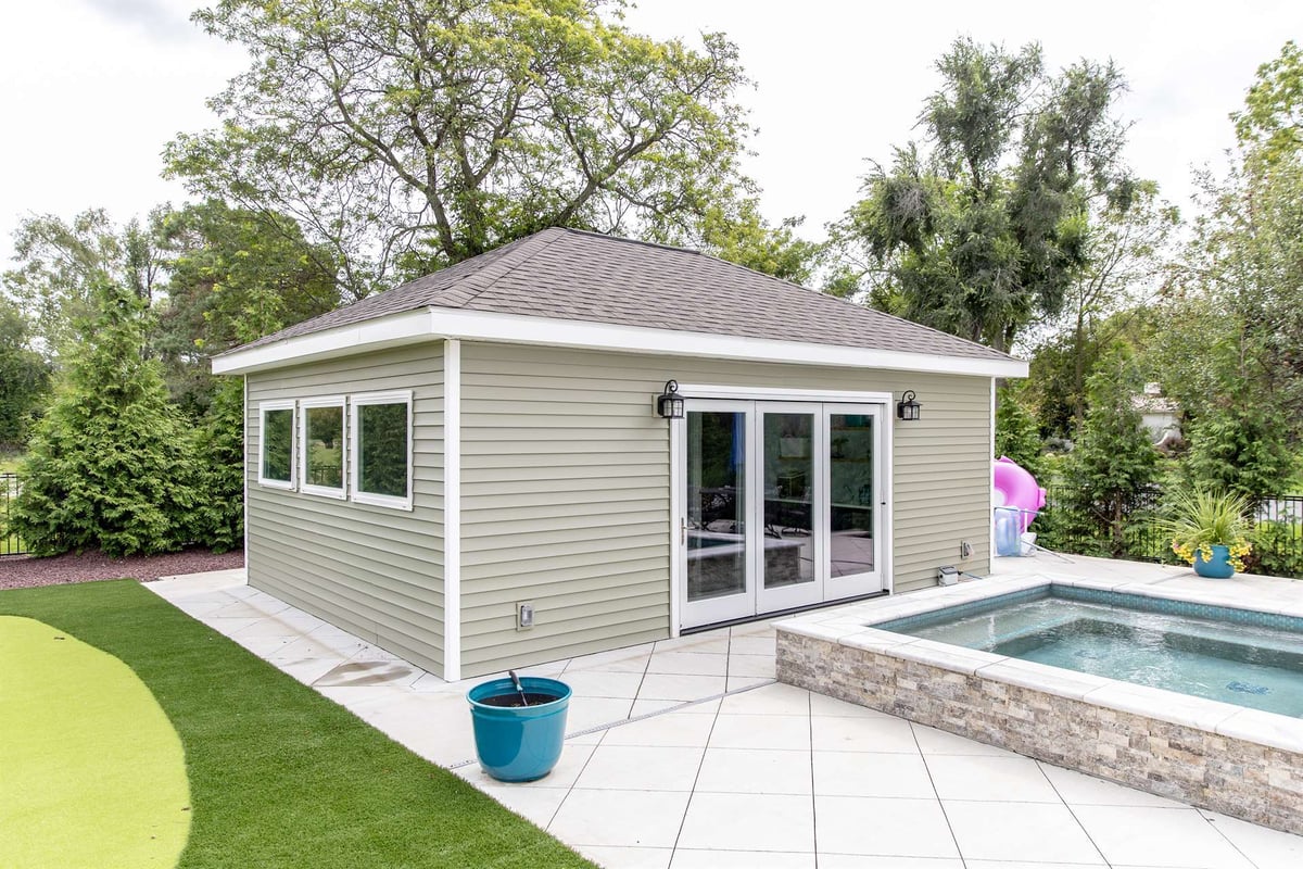 pool-house-exterior-with-sliding-doors-spa-and-putting-green-southeast-mi-optimized