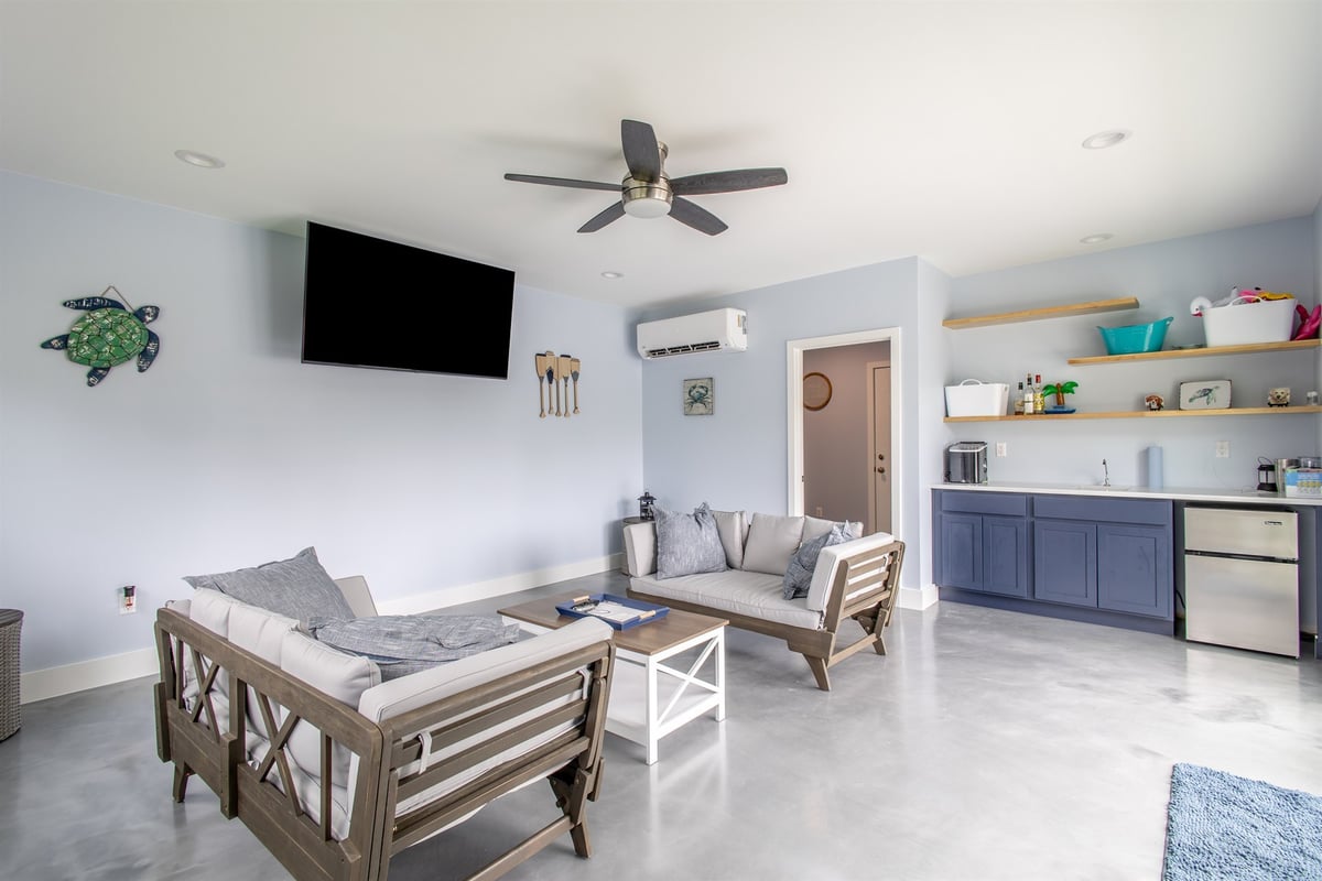 pool-house-interior-with-seating-a-wet-bar-and-concrete-floors-southeast-mi-optimized