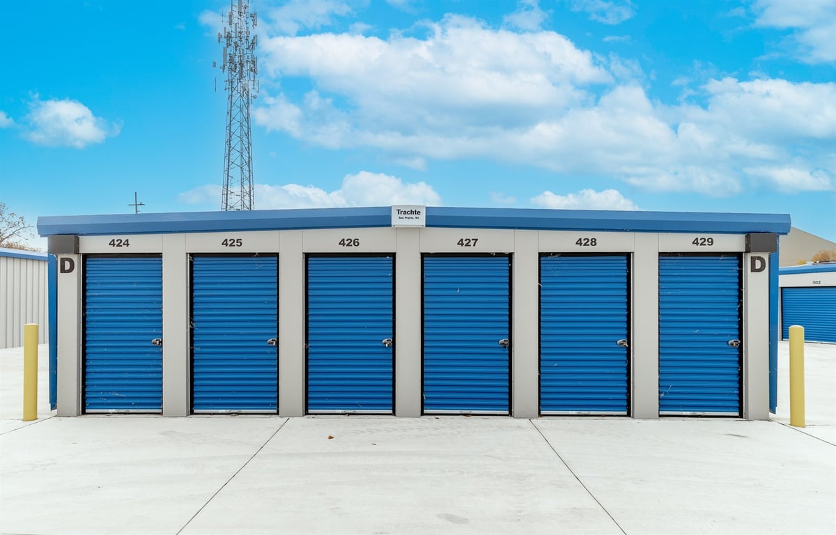exterior-row-of-large-blue-drive-up-doors-under-a-cell-tower-commercial-self-storage-southeast-mi-optimized
