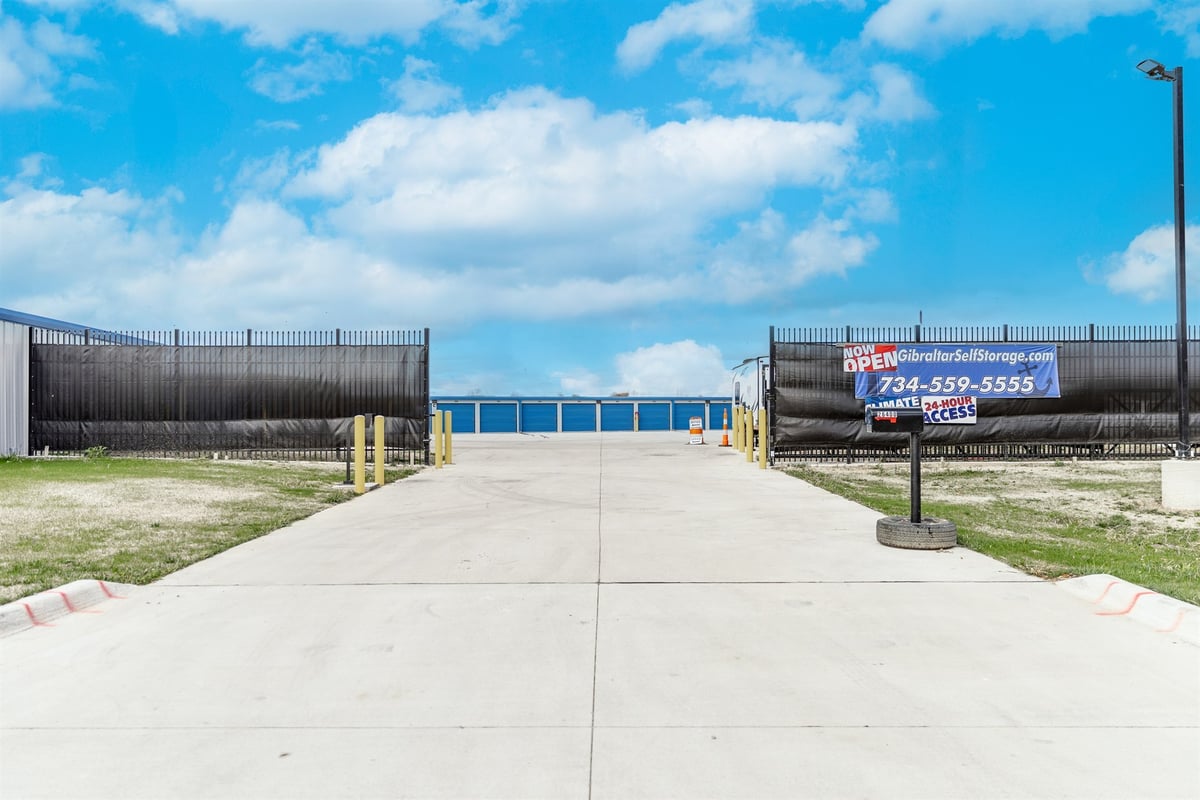 gated-entrance-with-a-security-fence-and-drive-up-approach-commercial-self-storage-southeast-mi-optimized