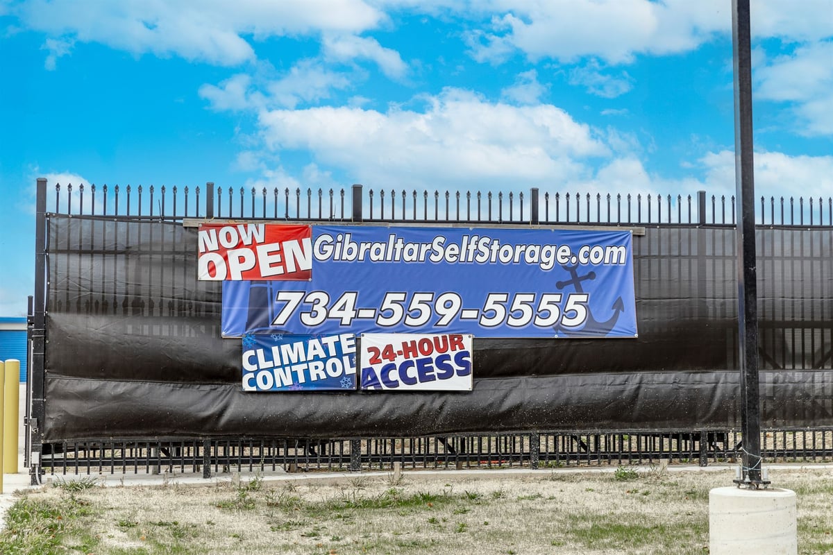 grand-opening-banner-on-the-entrance-security-fence-commercial-self-storage-southeast-mi-optimized