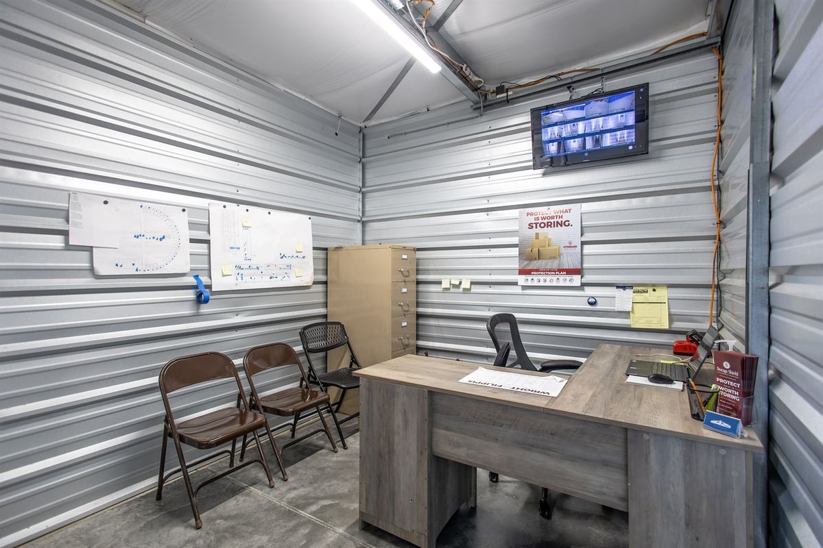 on-site-office-with-a-desk-chairs-and-security-monitor-commercial-self-storage-southeast-mi-optimized