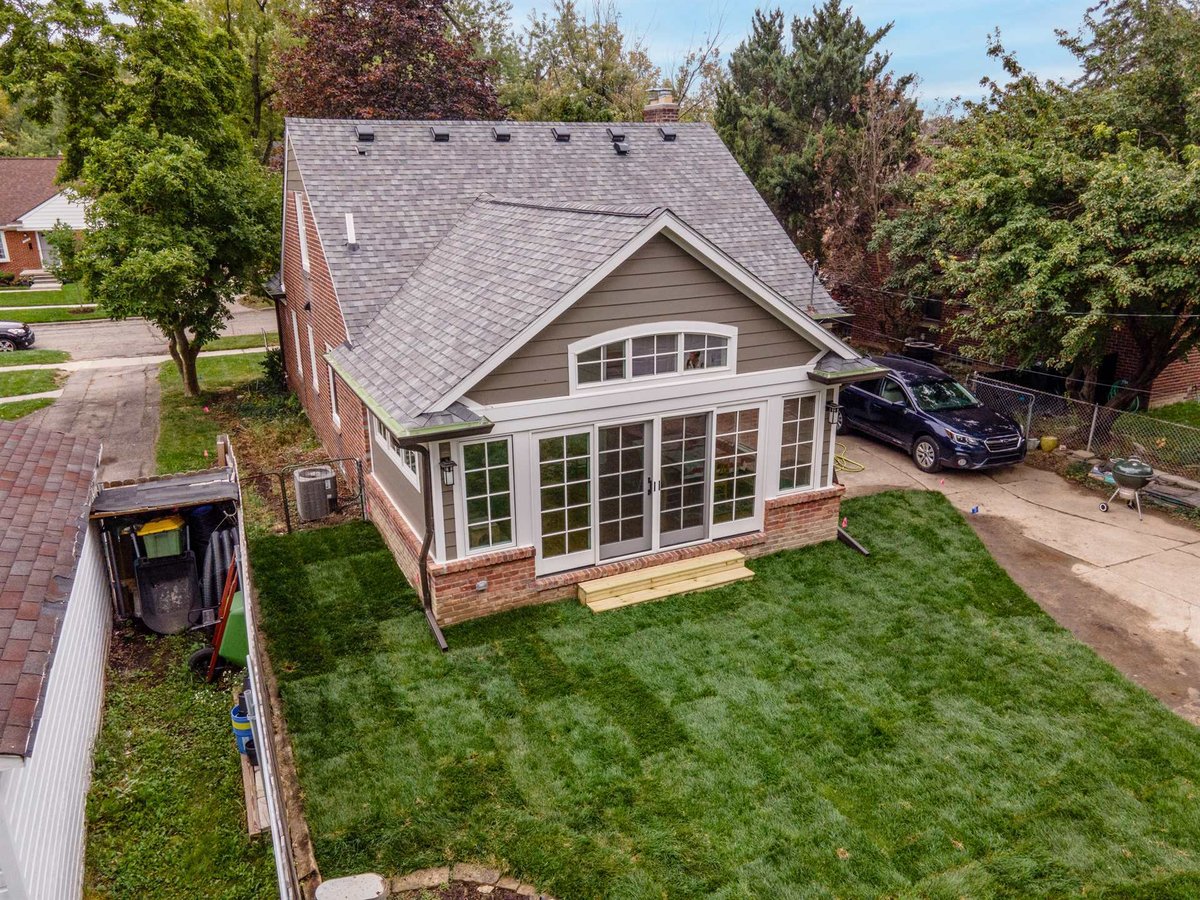 aerial-rear-showing-the-window-lined-sunroom-addition-and-driveway-southeast-mi-optimized