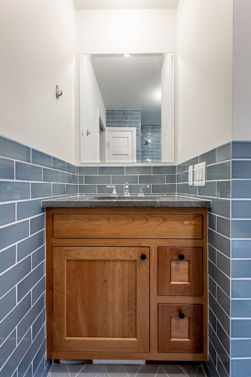 bathroom-vanity-in-wood-with-a-stone-top-and-blue-subway-tile-southeast-mi-optimized