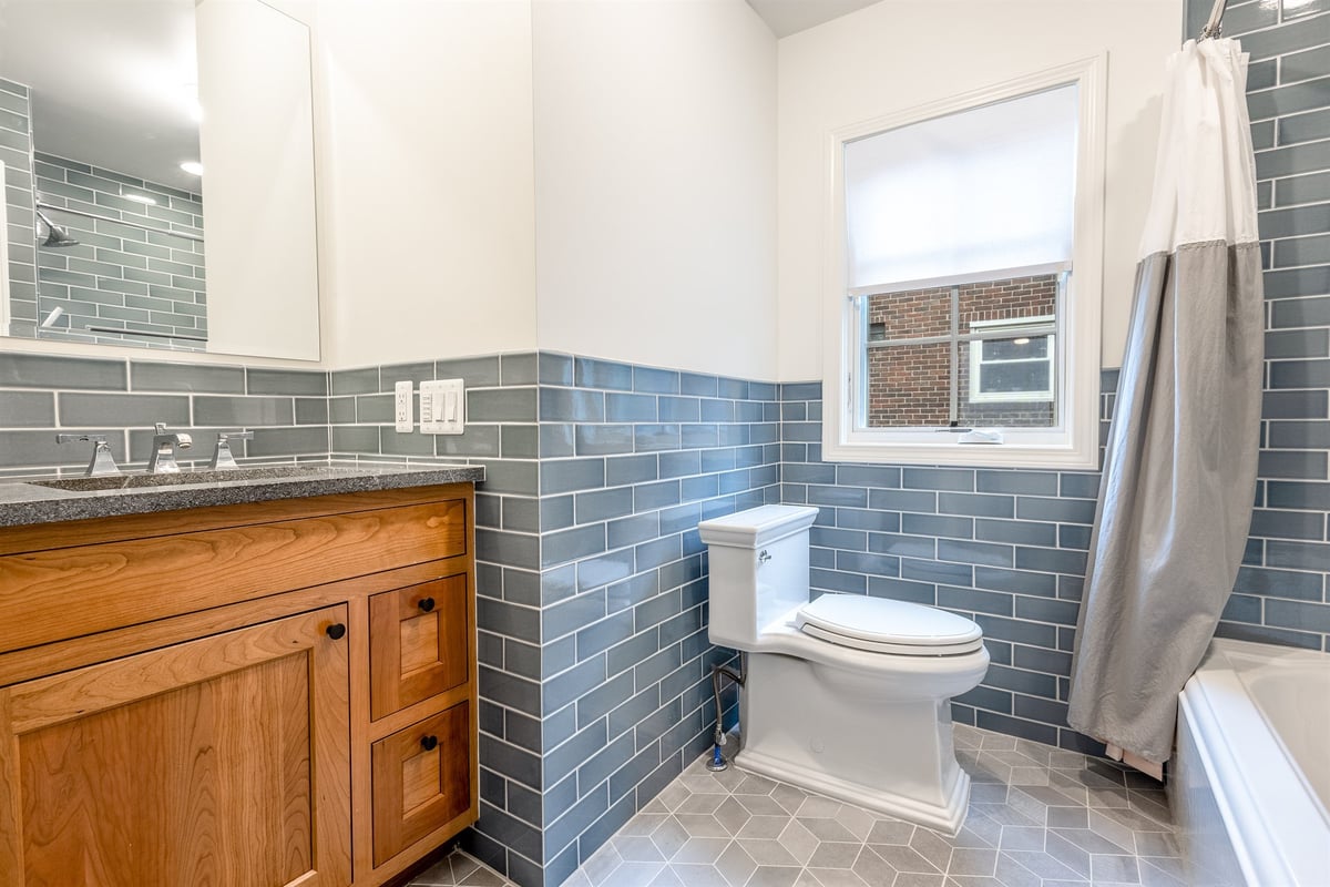 bathroom-with-a-wood-vanity-stone-top-and-blue-subway-tile-southeast-mi-optimized