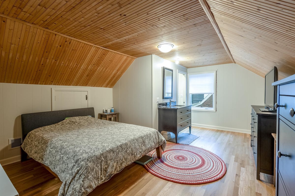 bedroom-with-a-vaulted-wood-plank-ceiling-and-hardwood-floors-southeast-mi-optimized