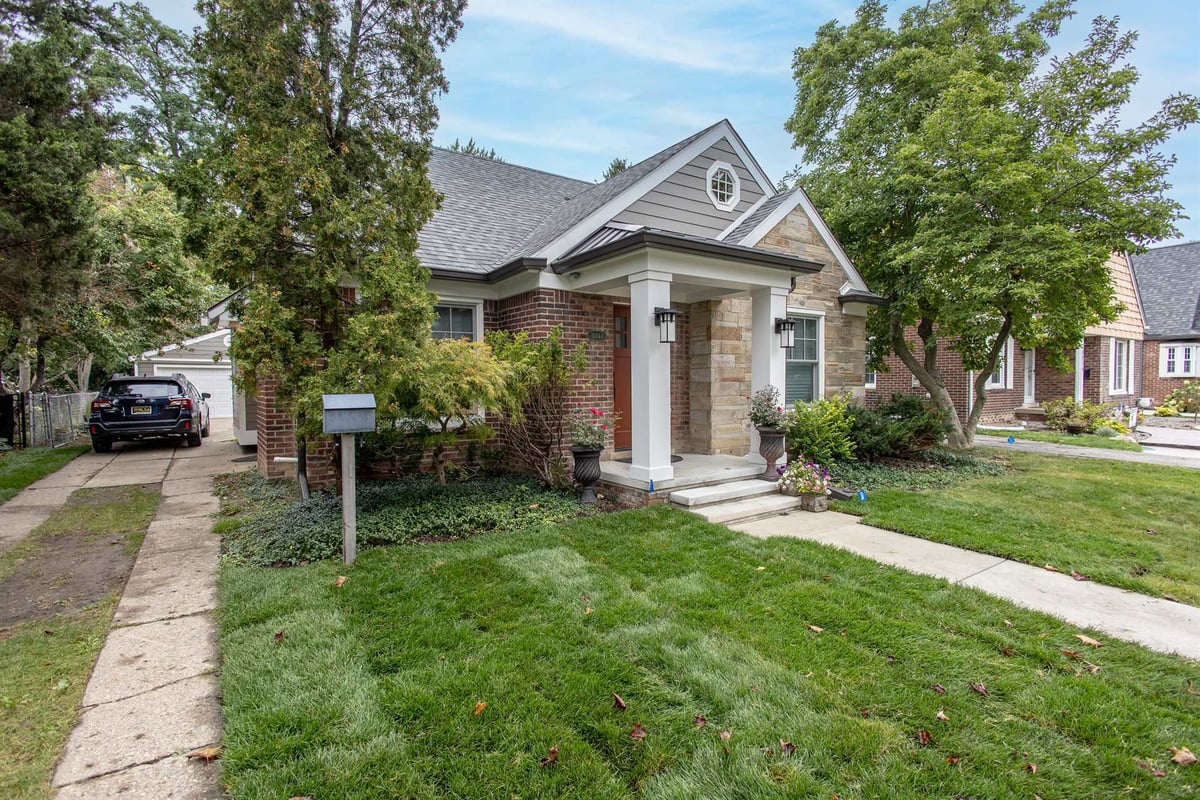 front-and-driveway-with-a-columned-porch-and-stone-facade-southeast-mi-optimized