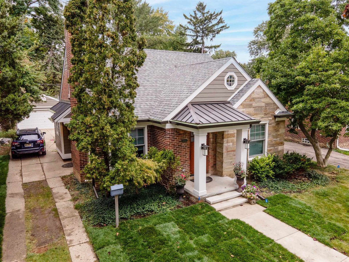 front-elevation-with-brick-stone-and-a-standing-seam-porch-roof-southeast-mi-optimized