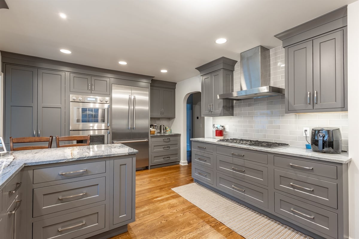 kitchen-with-gray-cabinets-a-stainless-hood-and-an-arched-doorway-southeast-mi-optimized