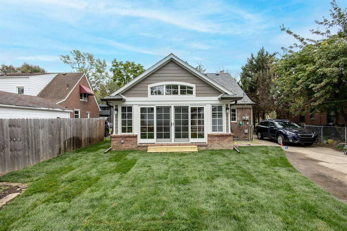 rear-addition-with-a-gabled-roof-and-a-wall-of-windows-over-the-lawn-southeast-mi-optimized