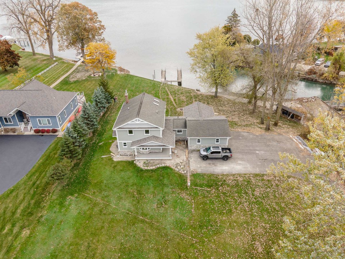 aerial-of-the-renovated-home-and-garage-on-a-waterfront-lot-with-a-dock-grosse-ile-mi-optimized