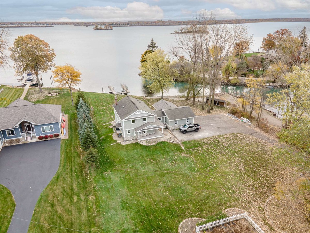 aerial-of-the-renovated-waterfront-home-with-a-dock-and-open-water-grosse-ile-mi-optimized