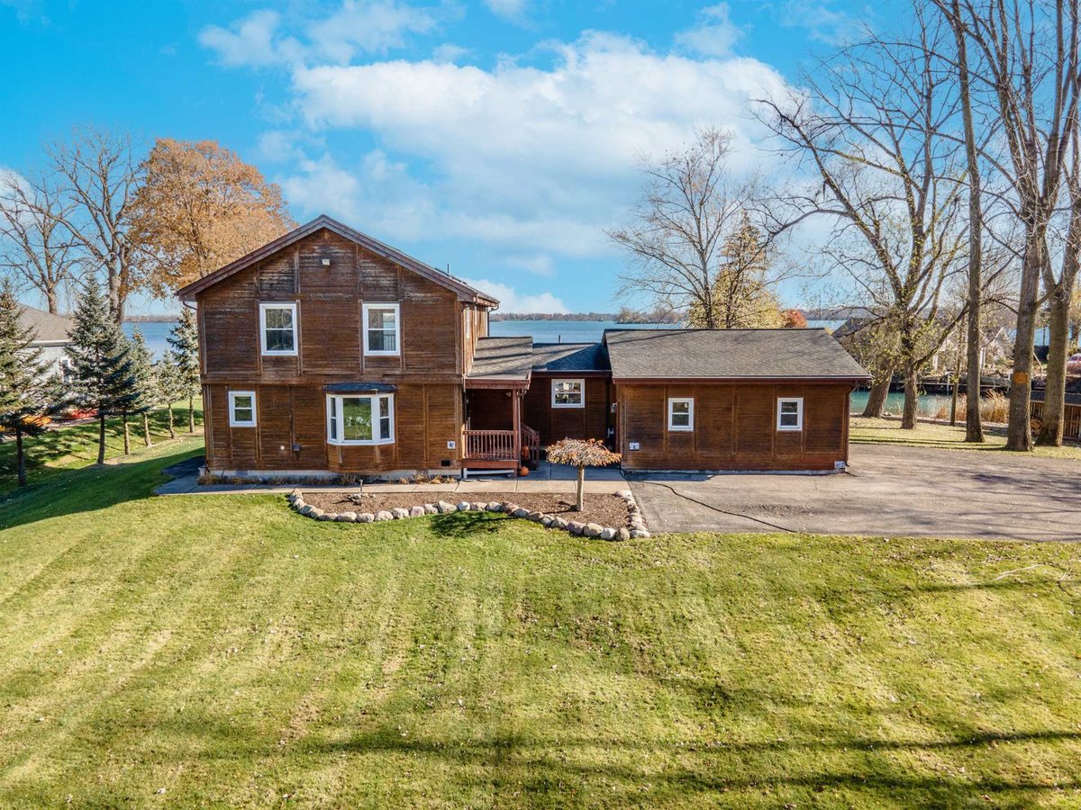 brown-wood-home-before-renovation-front-with-water-beyond-grosse-ile-mi-optimized
