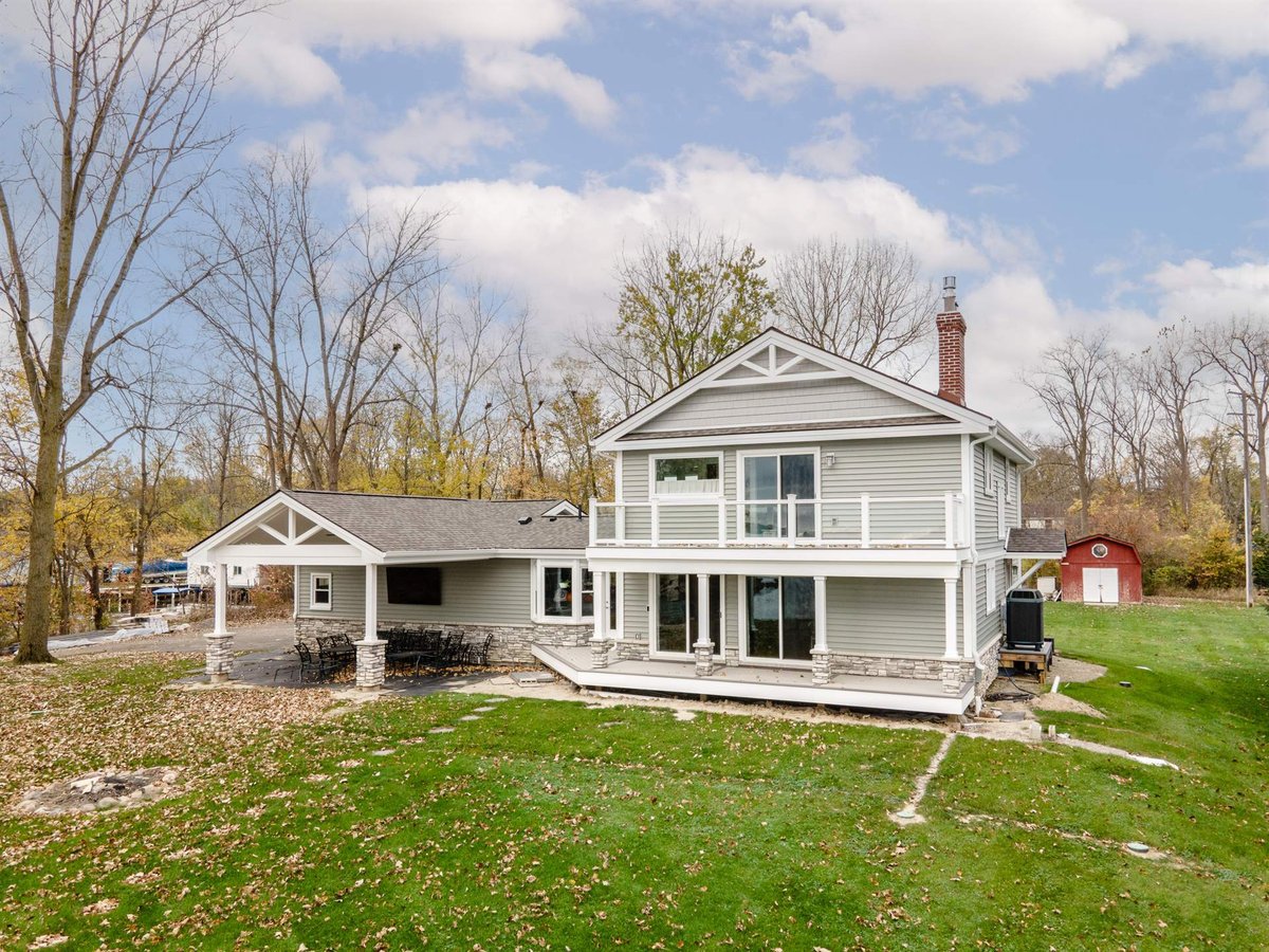 gray-home-after-renovation-rear-elevation-with-a-balcony-and-deck-grosse-ile-mi-optimized