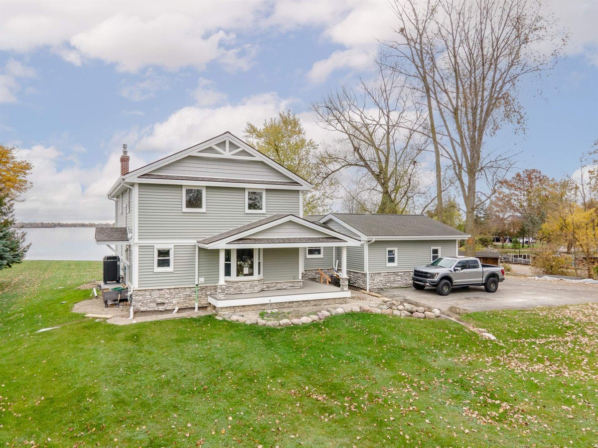 gray-two-story-home-after-renovation-front-corner-with-stone-and-porch-grosse-ile-mi-optimized