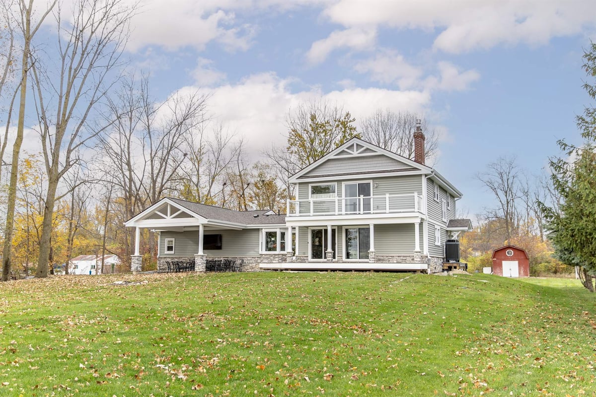gray-two-story-home-after-renovation-front-elevation-with-a-covered-porch-grosse-ile-mi-optimized