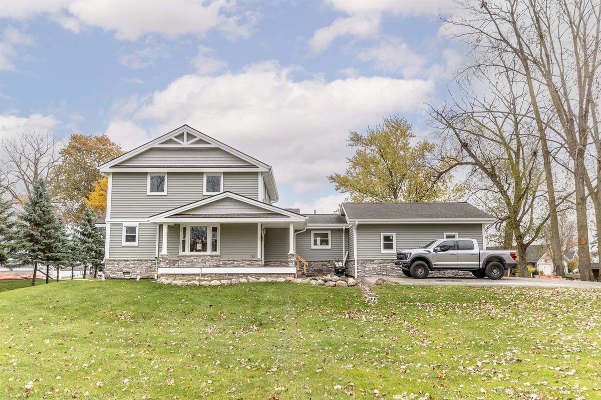 gray-two-story-home-after-renovation-front-with-porch-and-stone-grosse-ile-mi-optimized