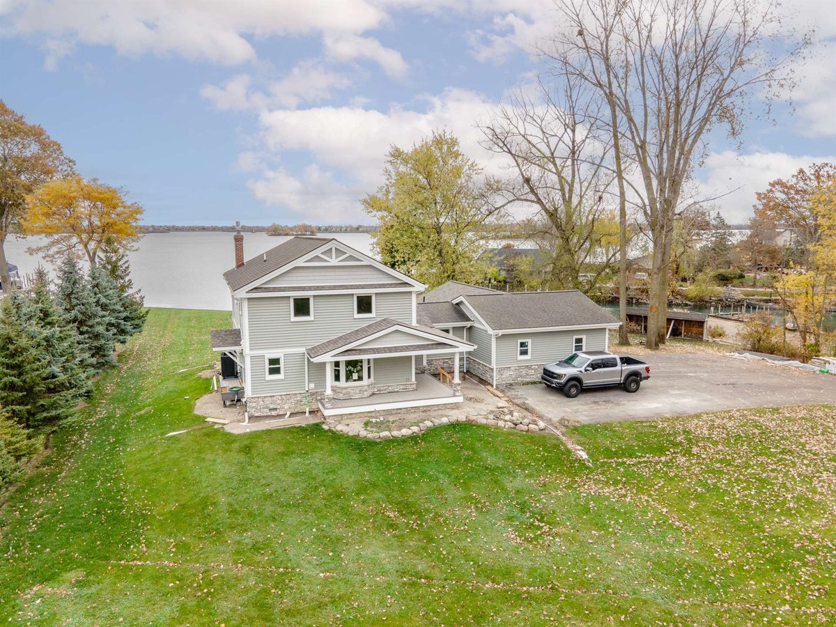 renovated-gray-home-with-attached-garage-aerial-front-on-a-waterfront-lot-grosse-ile-mi-optimized