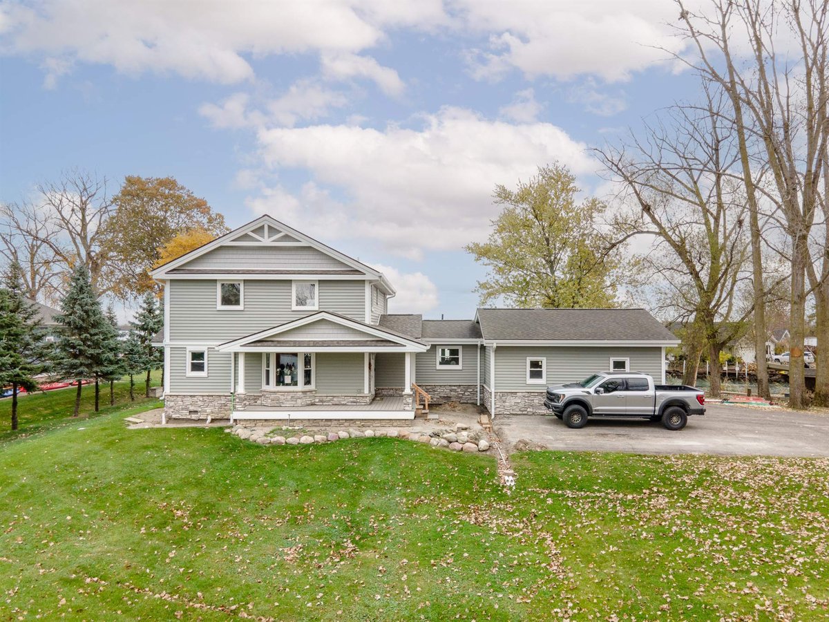 renovated-gray-home-with-attached-garage-front-angle-and-driveway-grosse-ile-mi-optimized