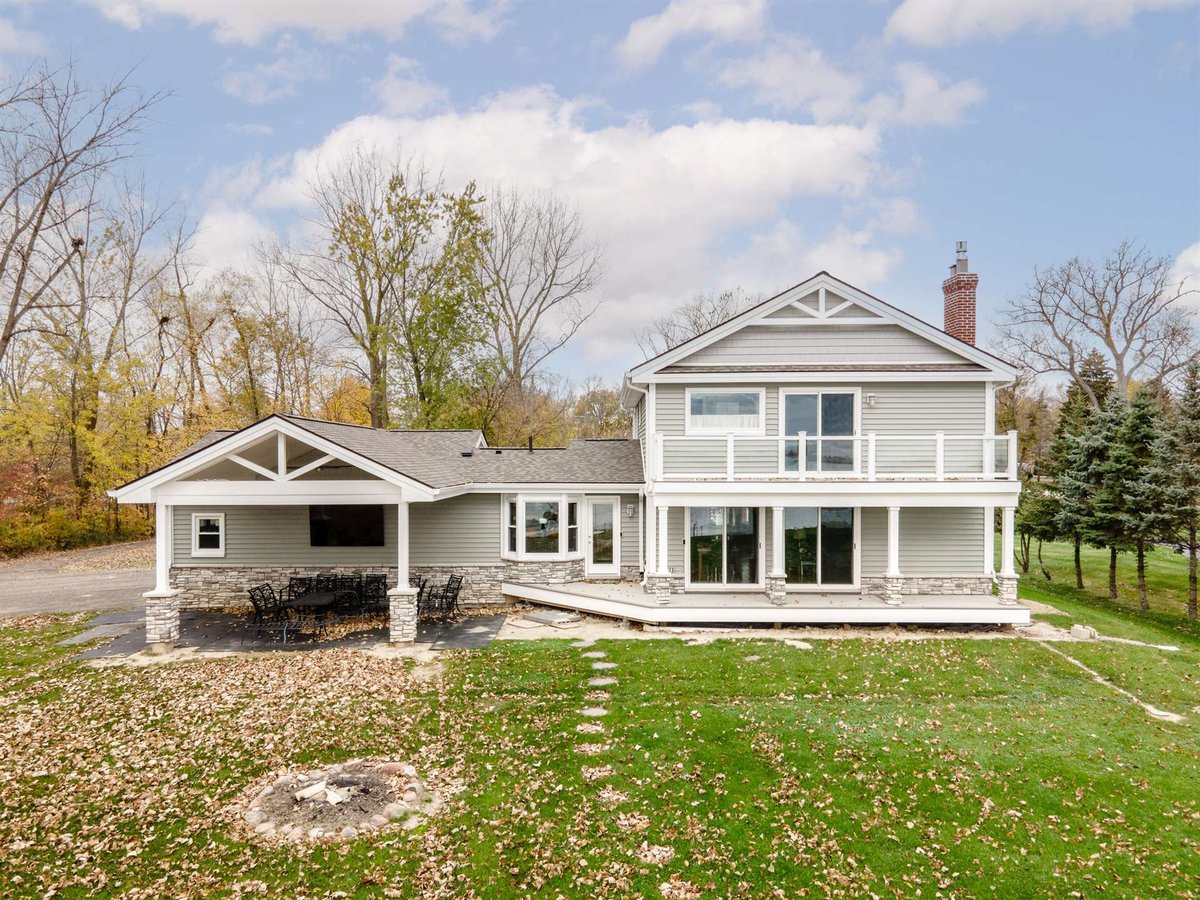 renovated-home-rear-covered-porch-with-stone-columns-and-upper-balcony-grosse-ile-mi-optimized