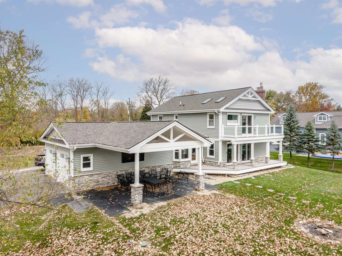 renovated-home-rear-with-a-covered-porch-and-stone-columns-grosse-ile-mi-optimized