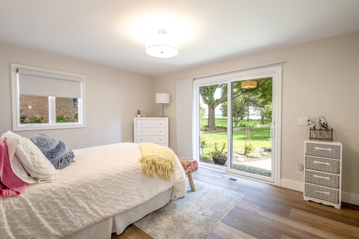 bedroom-with-sliding-doors-to-the-yard-and-hardwood-floors-southeast-mi-optimized