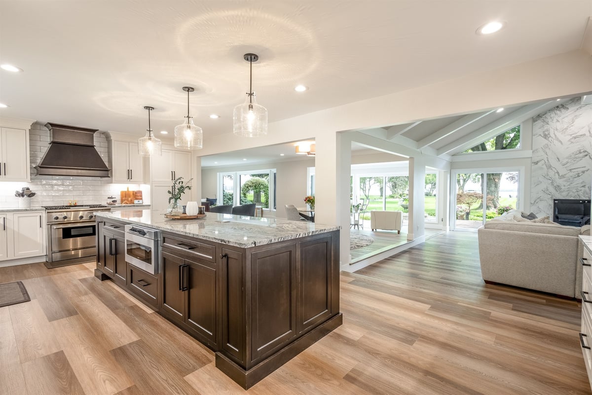 kitchen-with-a-dark-island-range-hood-and-pendants-open-to-the-living-room-southeast-mi-optimized