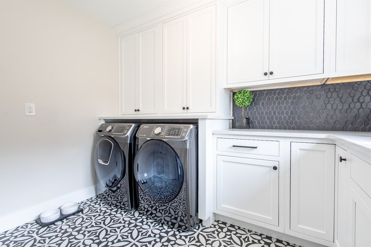 laundry-room-with-white-cabinets-black-hex-backsplash-and-patterned-floor-southeast-mi-optimized