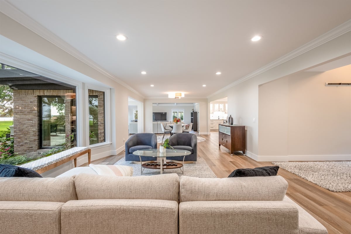 open-living-room-with-a-sectional-blue-chairs-and-a-stone-accent-wall-southeast-mi-optimized