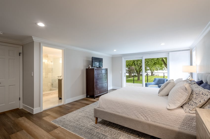 primary bedroom with an ensuite bath and sliding doors in southeast, mi