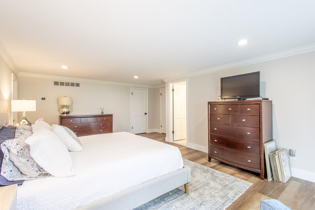primary-bedroom-with-two-dressers-and-hardwood-floors-southeast-mi-optimized