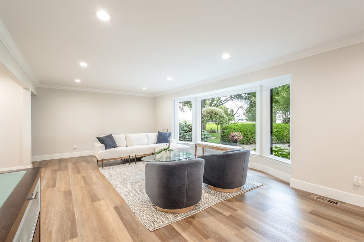 sitting-area-with-a-sofa-swivel-chairs-and-a-wall-of-windows-southeast-mi-optimized