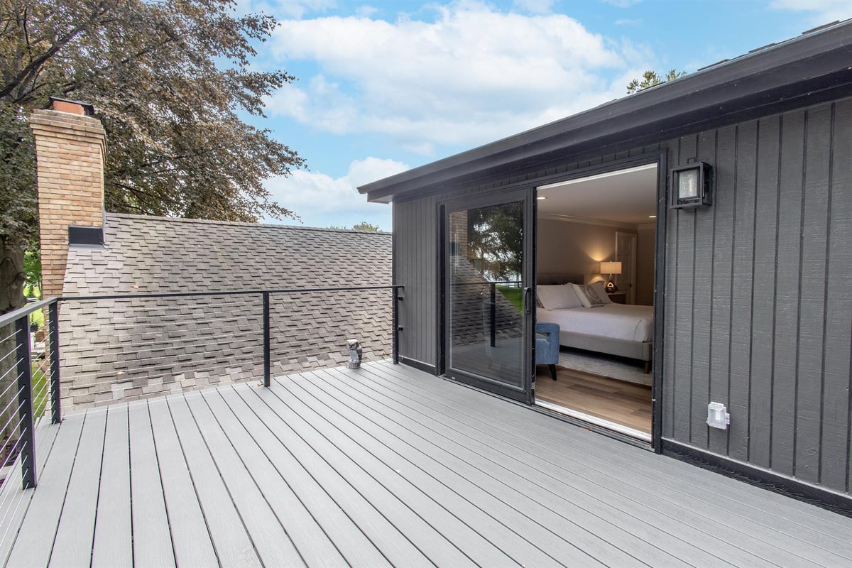 upper-composite-deck-off-a-bedroom-with-dark-board-and-batten-siding-southeast-mi-optimized